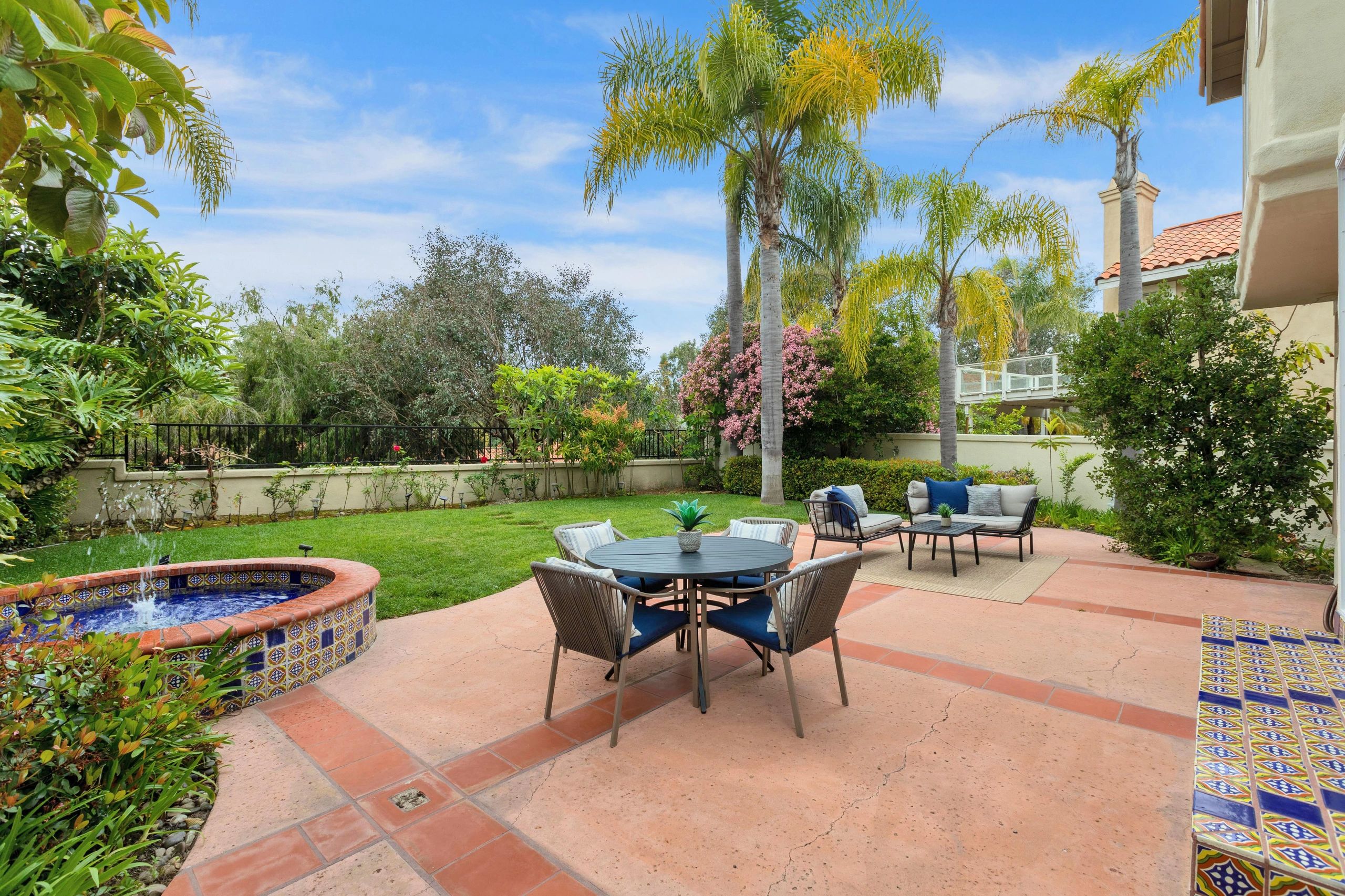 Backyard patio with outdoor dining and fountain