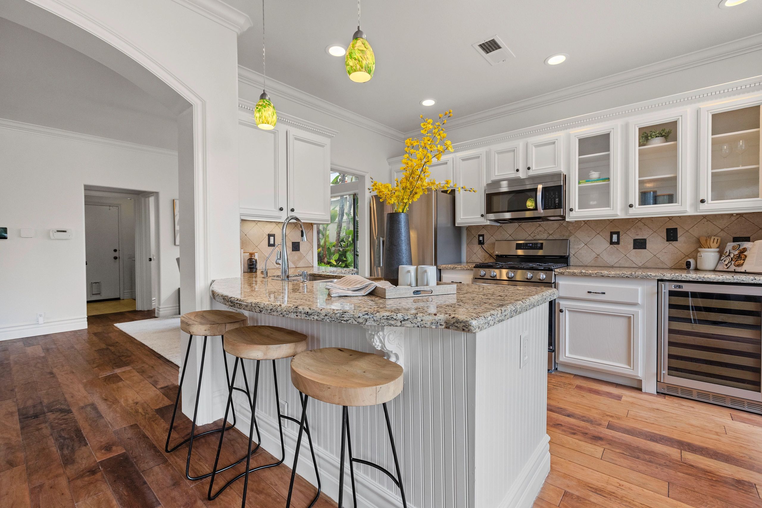 Modern kitchen with granite countertops and curved island